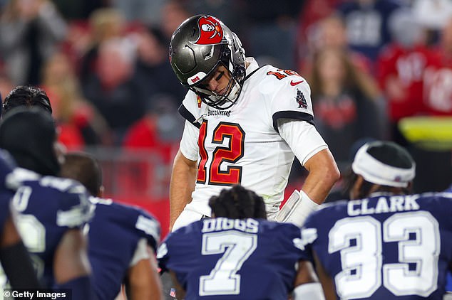 Tom Brady #12 of the Tampa Bay Buccaneers watches during an injury timeout during the fourth quarter against the Dallas Cowboys in the NFC Wild Card playoff game at Raymond James Stadium.