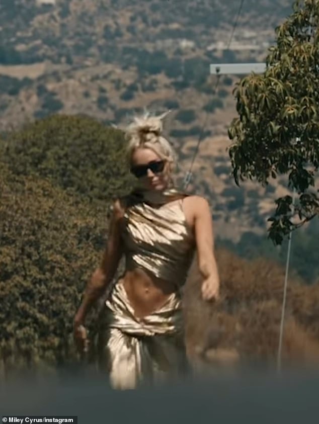 Miley seems to take several jabs at her ex-husband in her new song.  She appears here in the music video for the song.