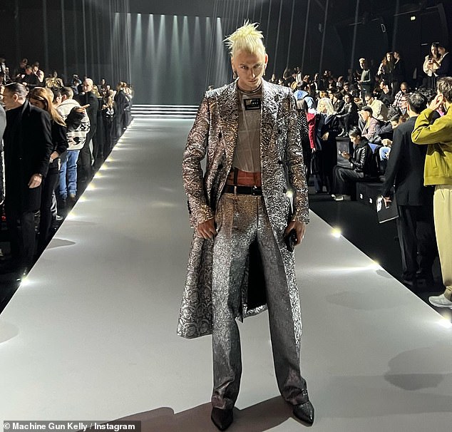 Eye-catching: The rapper, whose real name is Colson Baker, opted for a metallic silver suit in a few other snaps shared in the photo series