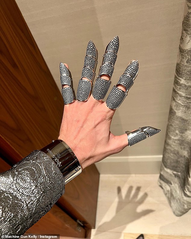 Accessories: The Bloody Valentine singer showed off his stunning pieces that draped his fingers, along with a chunky silver Dolce & Gabbana bangle on his left wrist