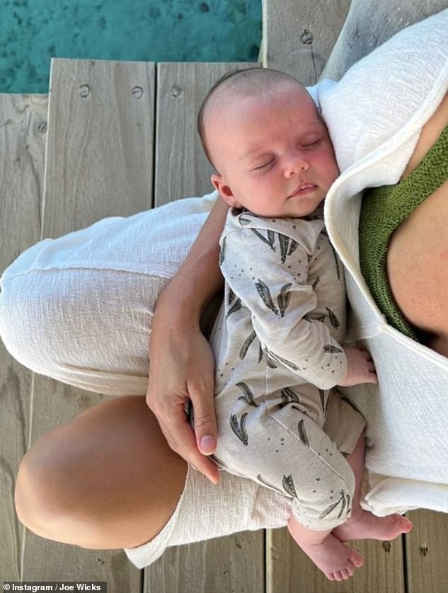 Time Out: Joe also shared an adorable image of Rosie cradling her baby, after they announced their arrival on September 8