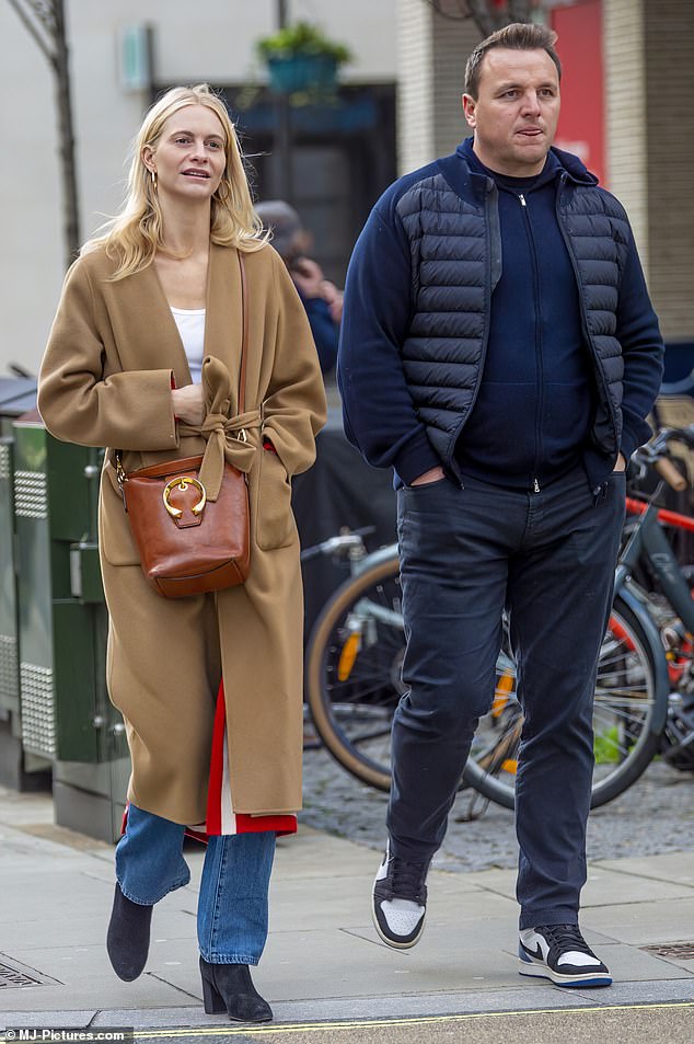 Style: The model and socialite, 36, looked effortlessly chic in a long camel coat, white blouse and light blue denim jeans while stepping out