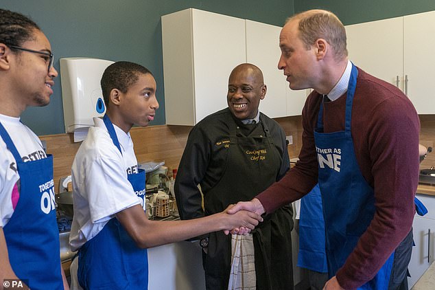 The Prince of Wales shakes hands with Ramae Bogle 13, during his visit to Together as One in Slough today.