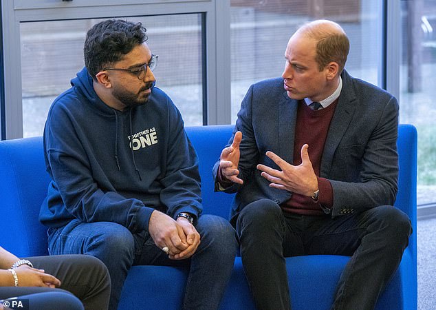 The Prince of Wales speaks to support worker Faizaan Hamid during his visit to Together as One