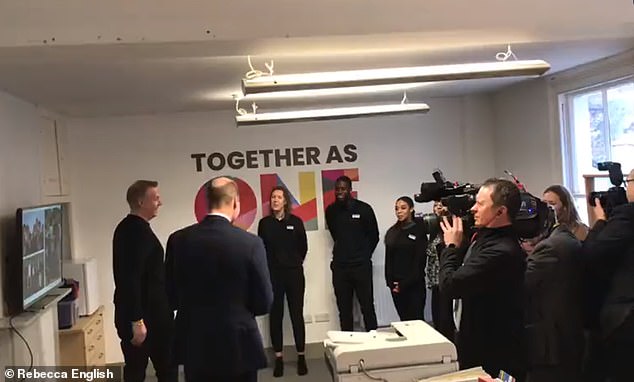 Prince William is pictured greeting staff and volunteers at the Together as One center in Slough this morning.