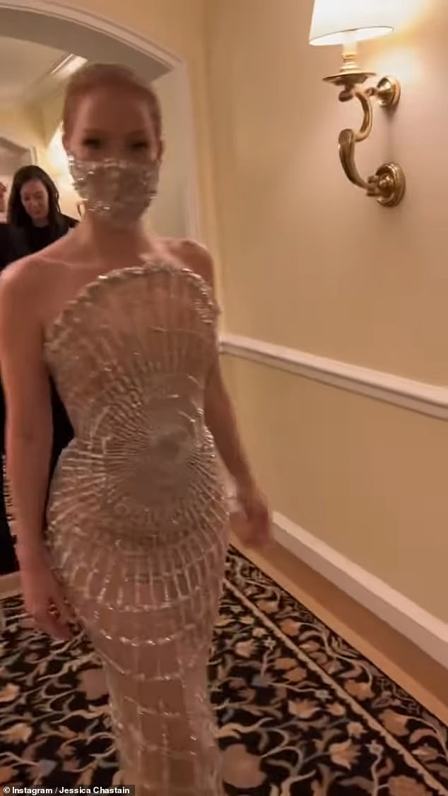 Here she is!  In a video posted to Instagram, Jessica revealed that she had donned a shiny silver mask to match her dress as she left her hotel and headed down the red carpet.