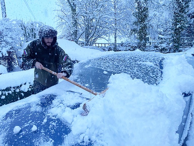 The nationwide freeze is predicted to last until Friday, and while temperatures have already hit 14.4°F (-9.8°C) in Yorkshire, lows are expected of up to 12.2 °F (-11°C). Pictured: A man brushes snow from his car in Muir of Ord where up to a foot of snow has fallen