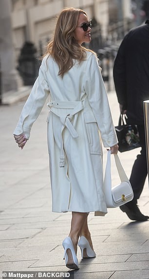 On trend: She also wore a pair of white stilettos, adding inches to her frame