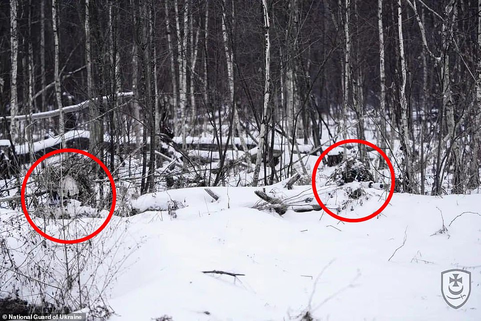 At least two snipers were seen in this photograph aiming their rifles just to the right of the camera lens.  But are there more hiding behind them in the dense snow-covered forest?