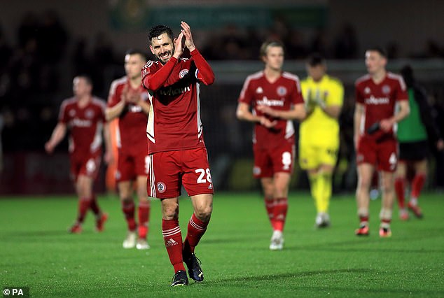 Accrington players applaud fans after drawing 1-1 with Boreham Wood in the third round