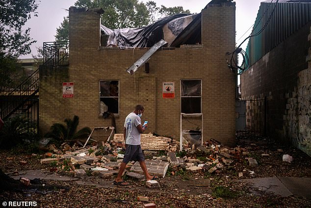 A resident surveys the damage to the Washington Gardens Apartments after it collapsed from the winds brought on by Hurricane Zeta in New Orleans in October 2020