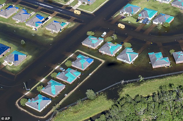 Water surrounds homes with tarps after Hurricane Delta in Iowa, Louisiana, in October 2020