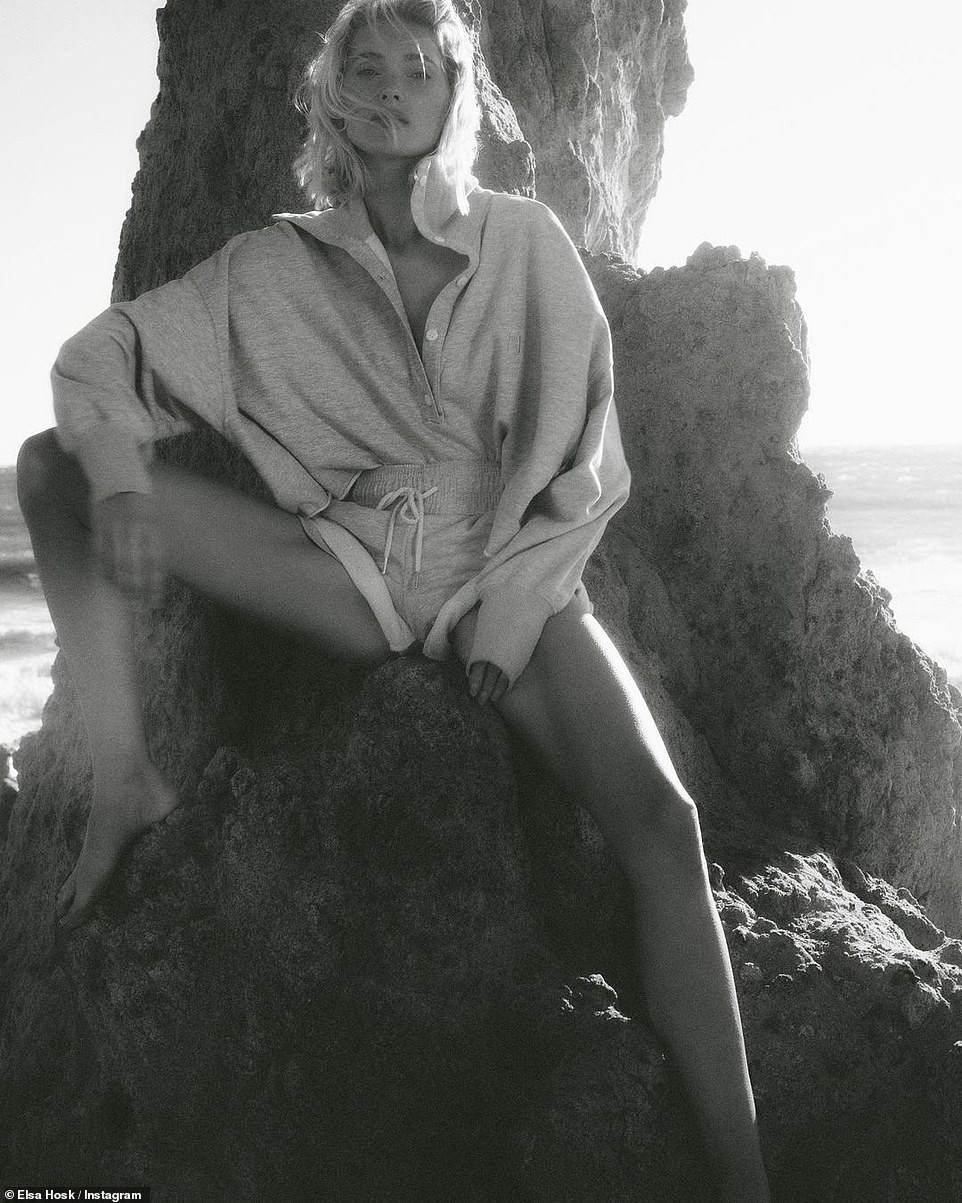 In a cover-up: Elsa wore a gray sweat suit as she posed with her legs spread while perched on a rock.