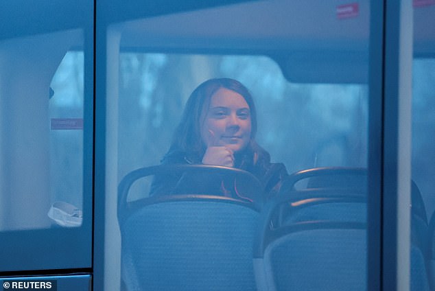 Climate activist Greta Thunberg gestures as she sits on a bus on the day of a protest against the expansion of German utility RWE's Garzweiler opencast lignite mine to Luetzerath, Germany today.