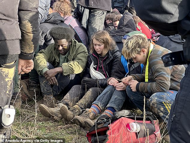 Thunberg appears within a group of protesters that was surrounded by several police officers.