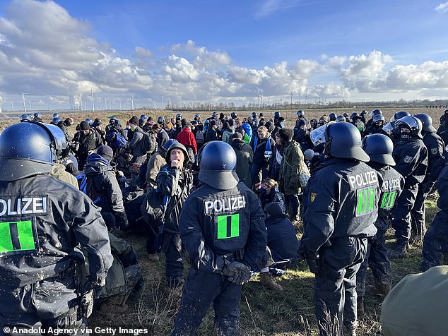 Police intervene in the protest as activists march and sit on the rails to block coal trains heading to the power plant in Lutzerath on Tuesday.