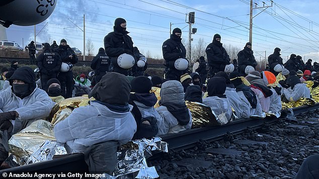 Activists sit on the rails to block the path of coal trains heading to the power plant in Lutzerath on Tuesday.