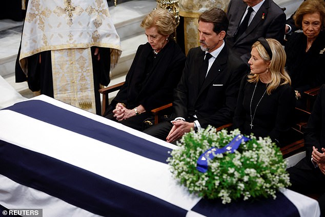 King Constantine II's wife, Queen Anne Marie, their son, Crown Prince Pavlos, and Pavlos's wife, Princess Marie-Chantal, next to the monarch's coffin.