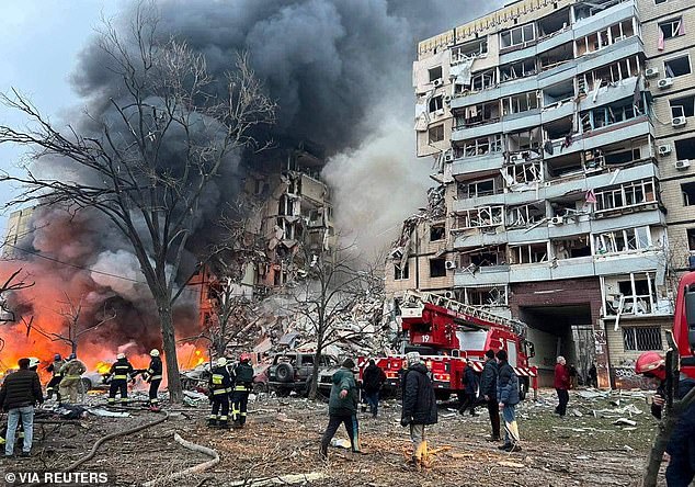 Rescuers are seen at an apartment building in Dnipro, Ukraine, on January 14, 2023, after it was hit by a Russian missile.