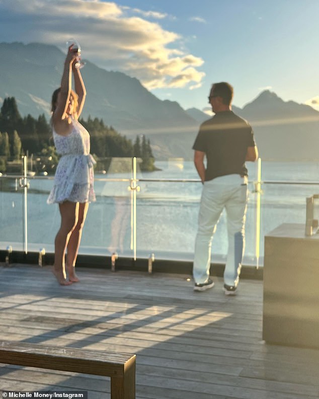 Stunning views: The two stood on a terrace near a body of water and mountains on their recent trip to New Zealand