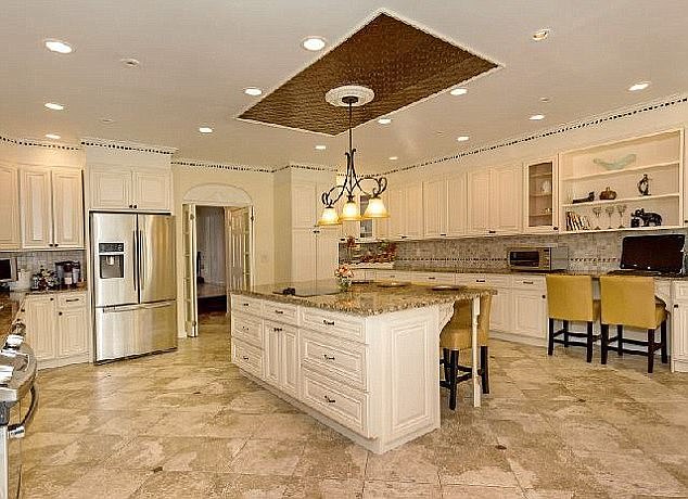 The house has marble countertops and white cabinets.