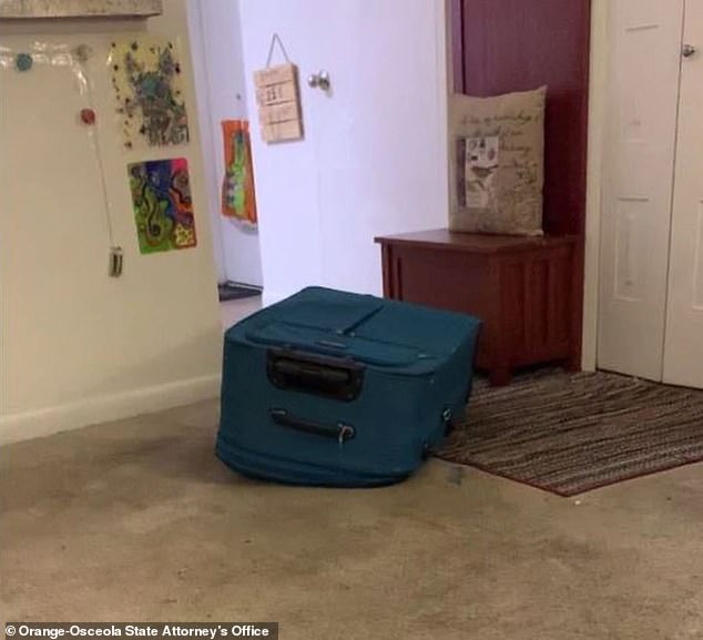 This screenshot from cellphone video purportedly recorded by Sarah Boone shows the blue suitcase where Jorge Torres Jr suffocated to death after zipping it inside.