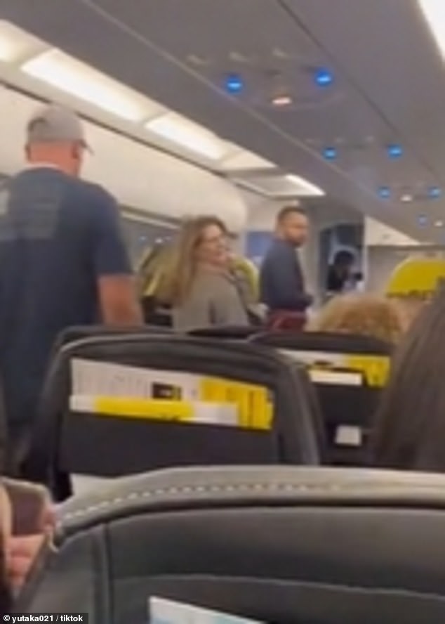 As she exited the plane, she turned and yelled at the other passengers who were making fun of her.