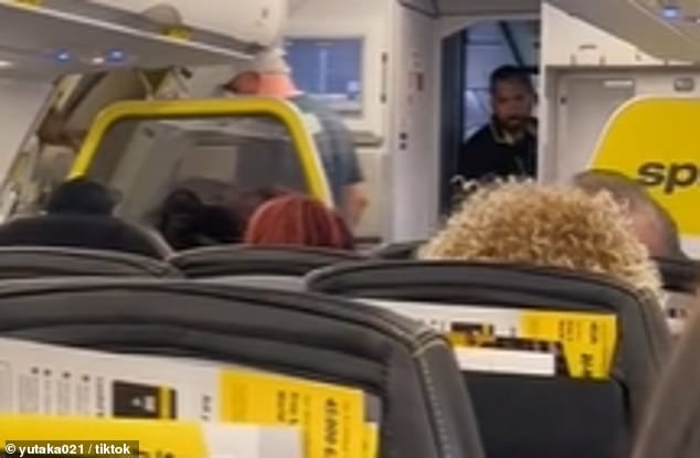 The woman was escorted off the plane by security teams and followed by a male escort.