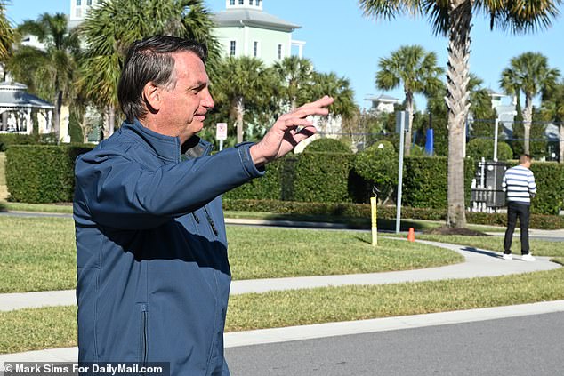 Wearing a blue fleece and navy pants, the 67-year-old moved freely and appeared to be in good health as he smiled and waved at fans.