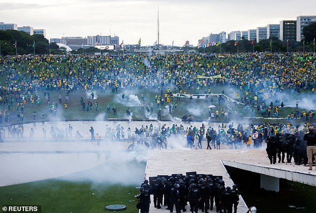 Supporters of former Brazilian President Jair Bolsonaro demonstrate against President Luiz Inacio Lula da Silva as security forces operate in front of the Brazilian National Congress in Brasilia, Brazil, on January 8, 2023.