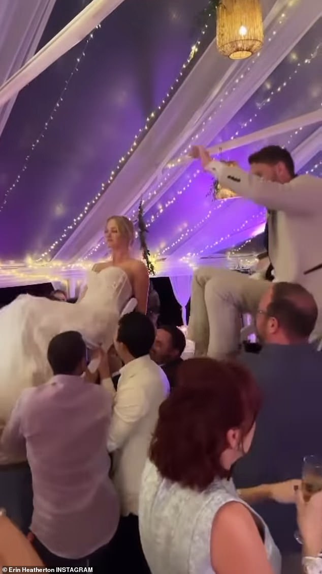 Celebrate: The couple was lifted into chairs by several male wedding guests as others cheered and music played