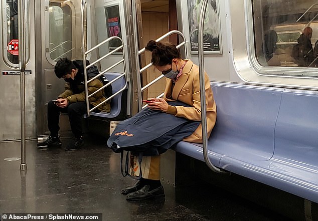 On the phone: The actress was on her phone while riding the subway