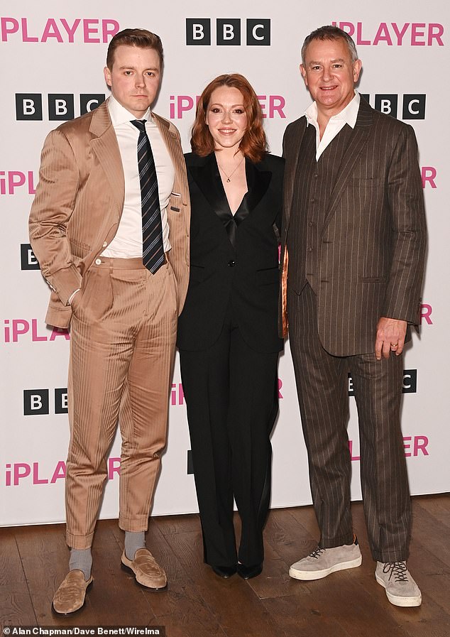 Say Cheese: Meanwhile, Jack (left) looked dapper in a beige satin suit which he wore with a white shirt and striped tie (pictured with co-star Hugh and Charlotte Spencer)