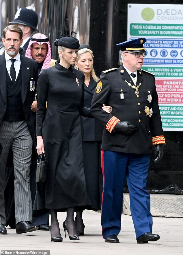 Charlene and Albert attended the funeral and were among several European royals to do so (pictured together at the event)