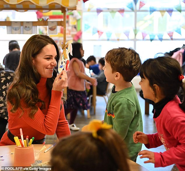 The children laughed as Kate beamed from behind the bunny mask she had created in a craft session.