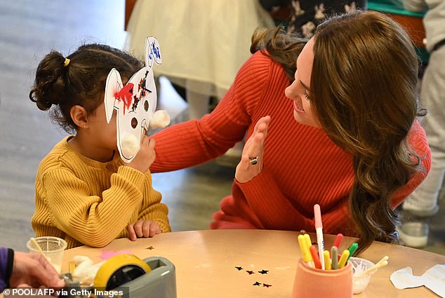 Hello!  After noticing that the cheeky boy next to her was playing with her mask, the princess waved at her.