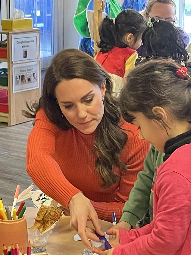 Hard at work!  The concentration on this young student's face is immeasurable when the Princess of Wales helps her with an assignment.