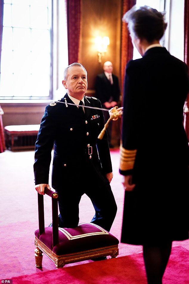 The Scottish police chief dips one knee as he receives his honor for services to the police and the public.