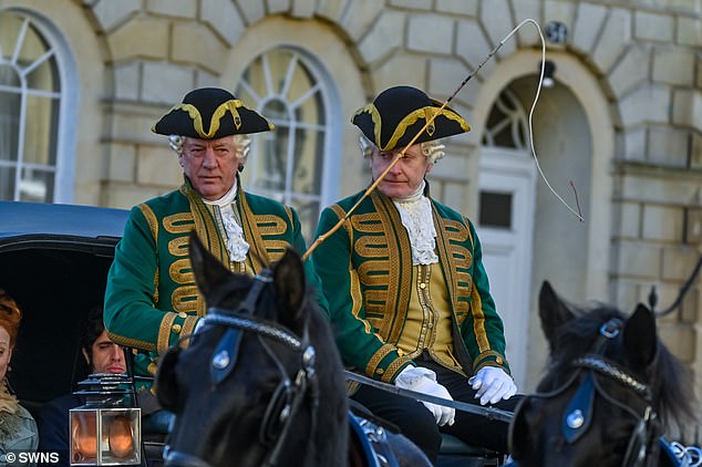 Away they go: Cast members sat in horse-drawn carriages as they rode through the city's historic streets for upcoming scenes.