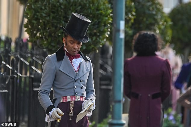 Dapper: Another donned a tall top hat and a striking gray and burgundy ensemble.