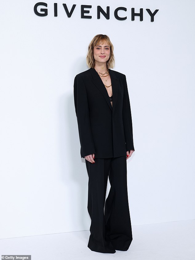 Chic: She was accompanied by Nora Arnezeder who accessorized her with a very similar black suit.  She opted for an oversized blazer and a pair of flared pants, wearing a bra under it.