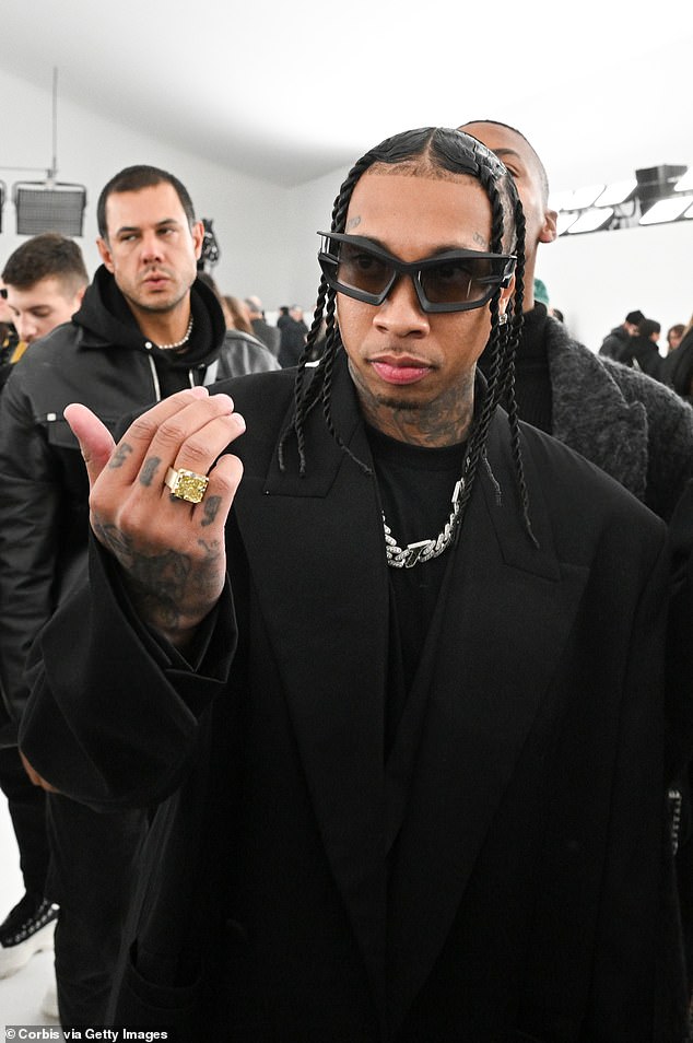 Looking good: Tyga was also in attendance at the fashion show, wearing an oversized black jacket and matching black t-shirt