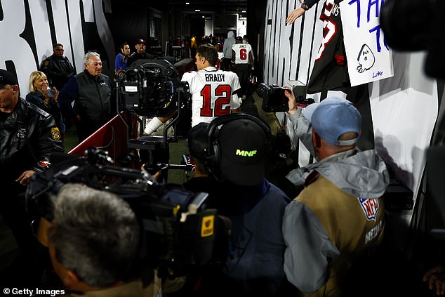 Was this the last goodbye for Tom Brady?  In the photo, the 45-year-old walks off the field at Tampa's Raymond James Stadium after Monday's playoff loss to the Dallas Cowboys.