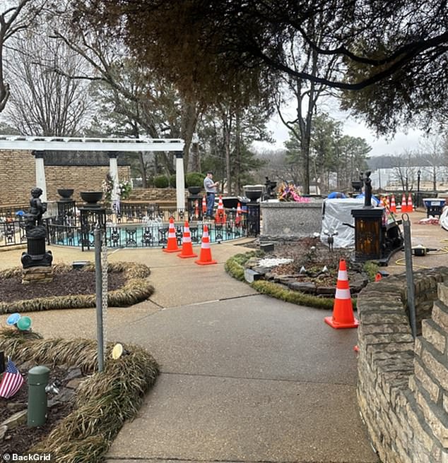 Workers can be seen digging his grave, which is right next to his son's and almost directly across from his father's (bottom left).