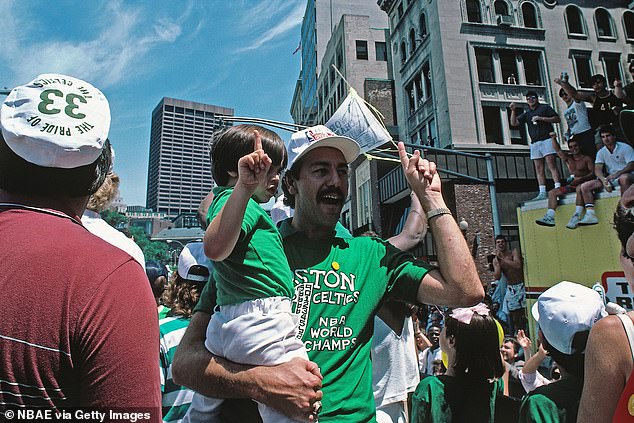 Assistant coach Chris Ford celebrates during a parade after winning the championship against the Houston Rockets circa 1986 at the Boston Garden.