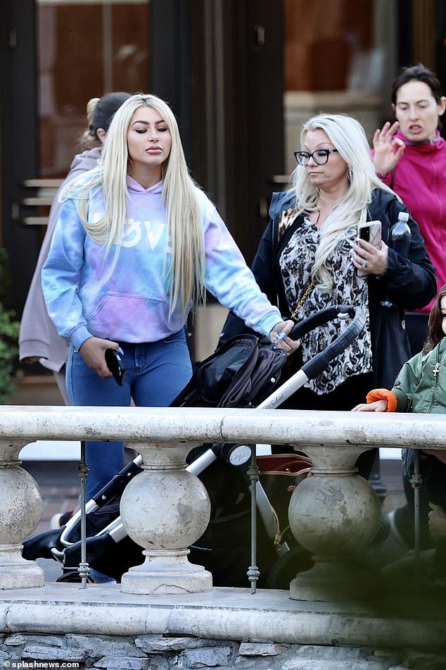 Loving: Melanie pushed her son's stroller as they headed out for the day