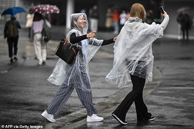 Despite Sydney hitting 30C for the first time in almost a year on Wednesday, temperatures have plummeted as an endless deluge begins (rain in Melbourne pictured)