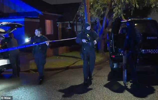 A young man is under police guard at hospital after a 91-year-old man was found dead in south-west Sydney (police on scene pictured)