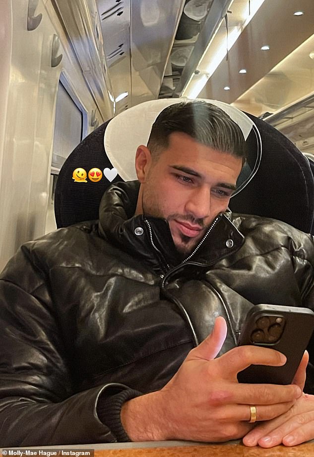 Her man: Molly-Mae also shared a snapshot of her boyfriend on the same train, without revealing where they were headed or, indeed, if they had secretly welcomed their son as well.