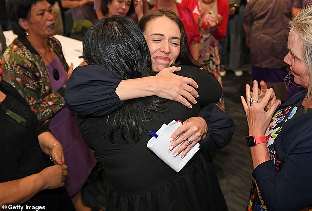 Ms Ardern hugs her fellow MPs after announcing she would be stepping down from the top post.